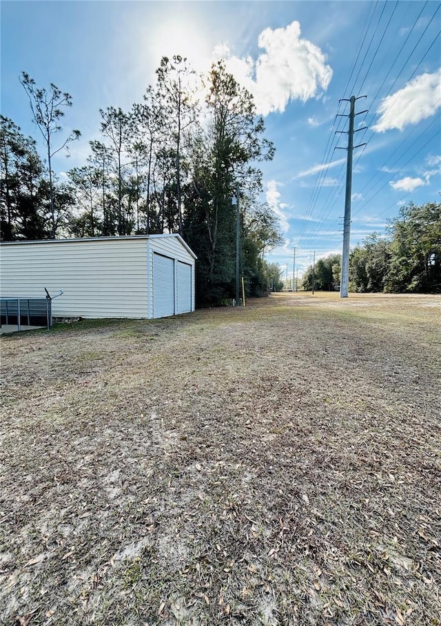 view of yard featuring an outbuilding and a garage