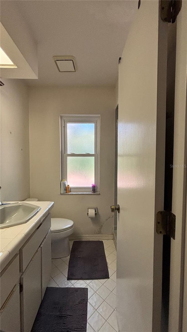 bathroom with vanity, tile patterned floors, and toilet