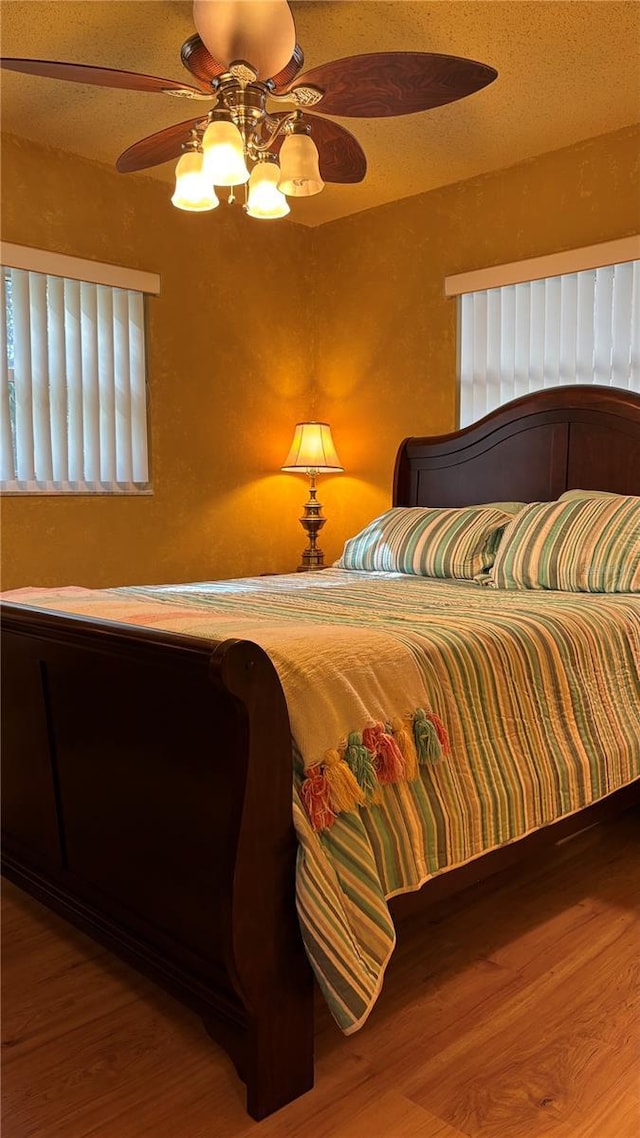 bedroom featuring hardwood / wood-style floors and ceiling fan