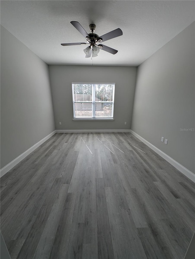 spare room featuring hardwood / wood-style flooring, ceiling fan, and a textured ceiling