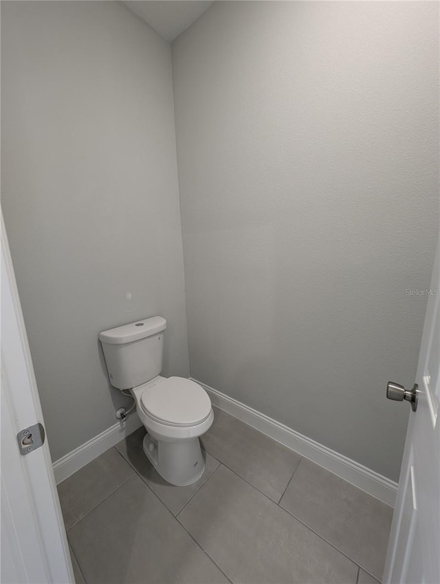 bathroom featuring tile patterned floors and toilet