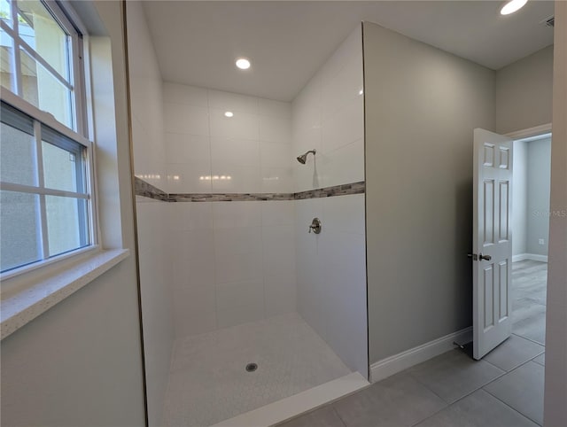 bathroom featuring tile patterned flooring, plenty of natural light, and tiled shower