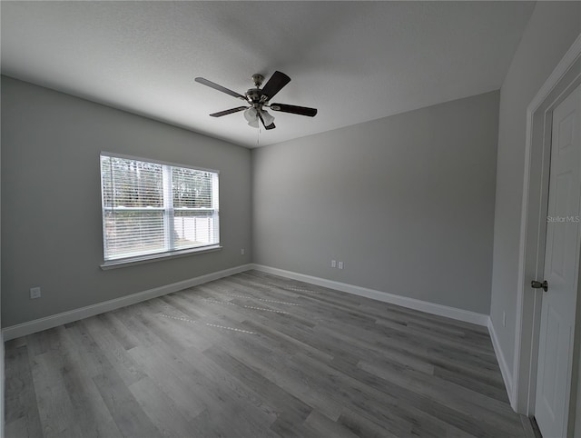 unfurnished room featuring ceiling fan, hardwood / wood-style floors, and a textured ceiling