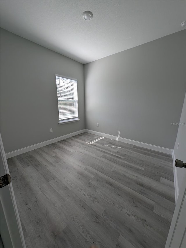 spare room with wood-type flooring