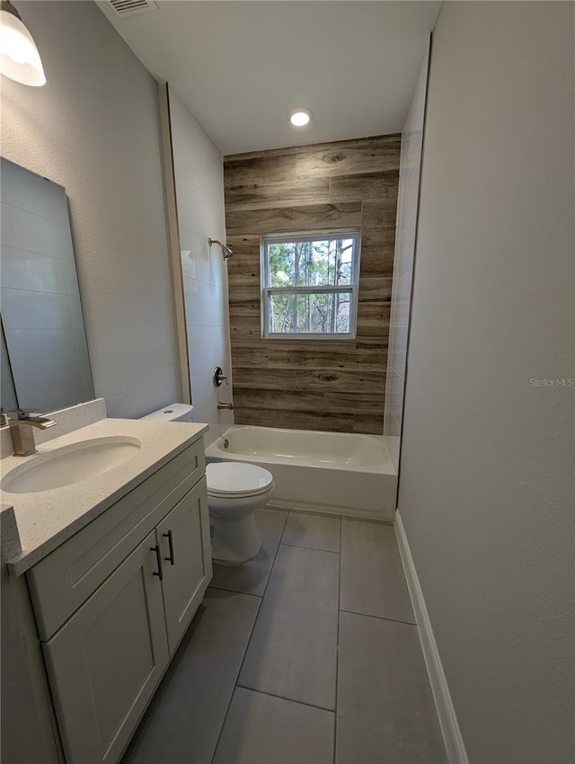 full bathroom with vanity, tiled shower / bath, tile patterned floors, and toilet