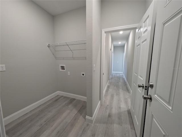 laundry area with hookup for an electric dryer, hookup for a washing machine, and light wood-type flooring