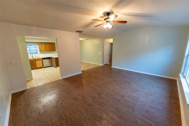 spare room with ceiling fan, sink, and light wood-type flooring