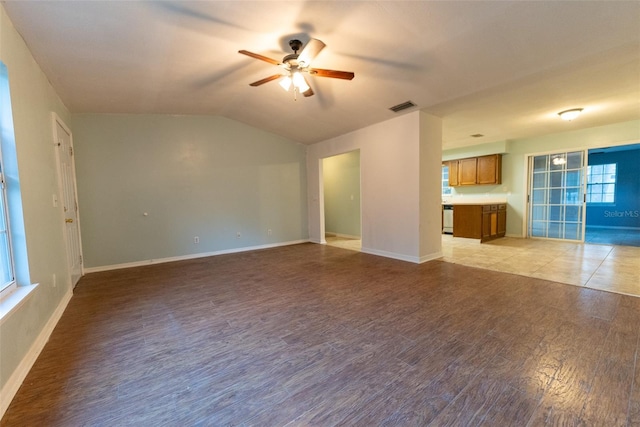 unfurnished living room featuring ceiling fan, vaulted ceiling, and light wood-type flooring