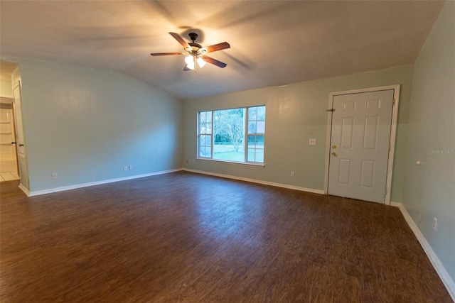 empty room with dark wood-type flooring, ceiling fan, and vaulted ceiling