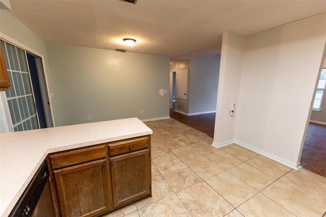 kitchen with light tile patterned floors and dishwasher