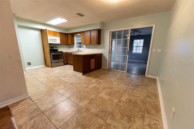 kitchen with ceiling fan, sink, stainless steel electric range, and light tile patterned floors