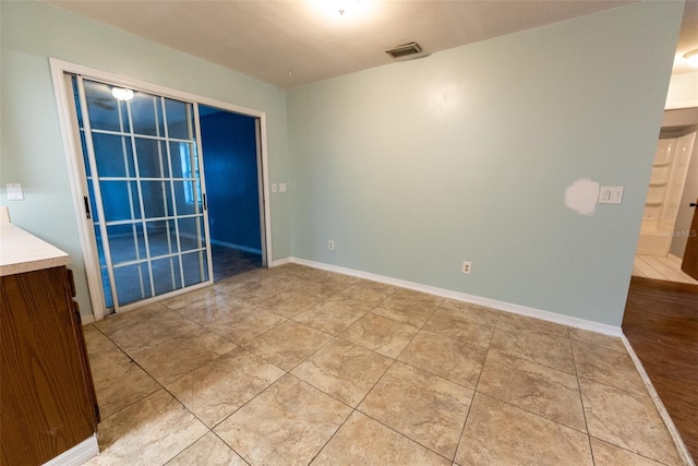 unfurnished room with tile patterned floors