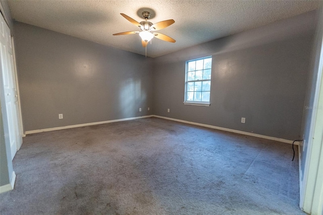 carpeted spare room with a textured ceiling and ceiling fan