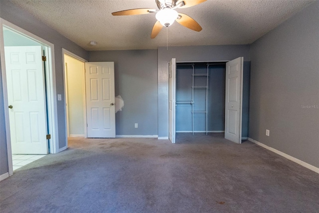 unfurnished bedroom with ceiling fan, a closet, carpet floors, and a textured ceiling