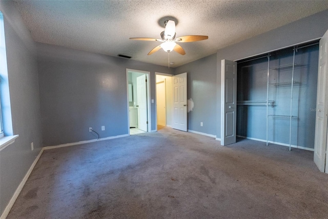 unfurnished bedroom featuring ceiling fan, carpet flooring, a closet, and a textured ceiling