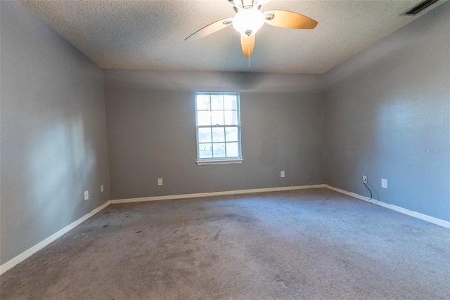 carpeted empty room with ceiling fan and a textured ceiling