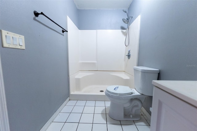 bathroom with vanity, tile patterned floors, toilet, and a shower