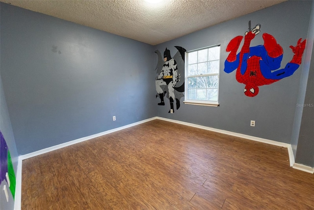 empty room featuring hardwood / wood-style floors and a textured ceiling