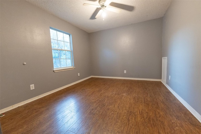 empty room with dark wood-type flooring, ceiling fan, and a textured ceiling