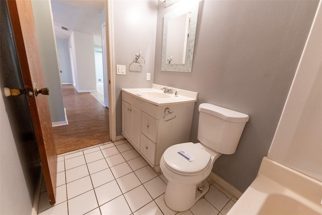 bathroom with vanity, tile patterned floors, and toilet