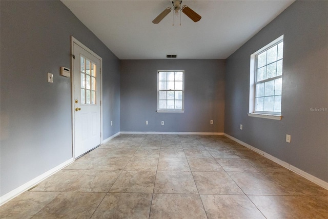 spare room with light tile patterned flooring and ceiling fan