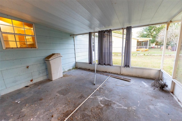 unfurnished sunroom featuring lofted ceiling