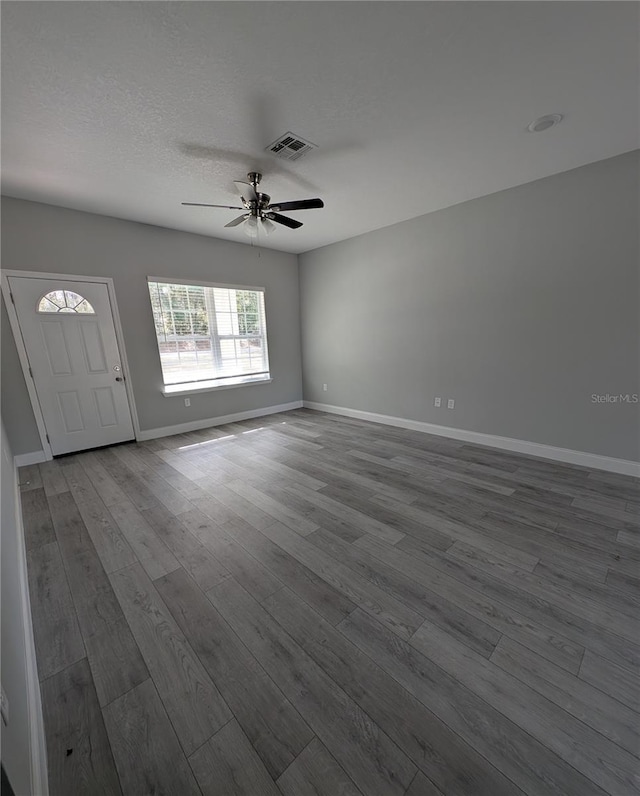 interior space with hardwood / wood-style floors, a textured ceiling, and ceiling fan