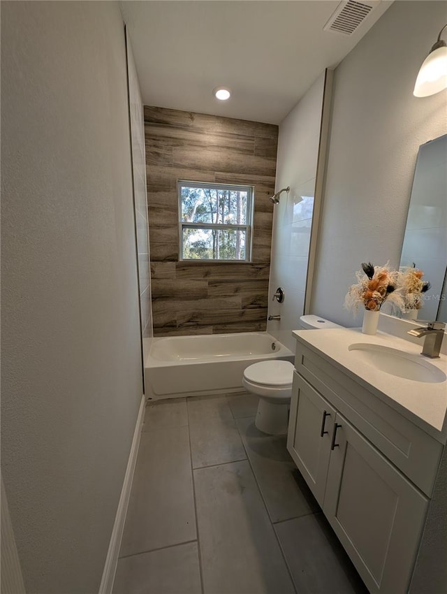 full bathroom featuring tile patterned flooring, tiled shower / bath, vanity, and toilet