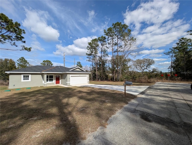 view of front of house with a garage and a front yard