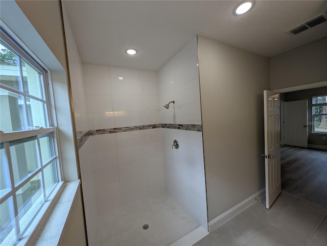 bathroom featuring tile patterned floors and tiled shower