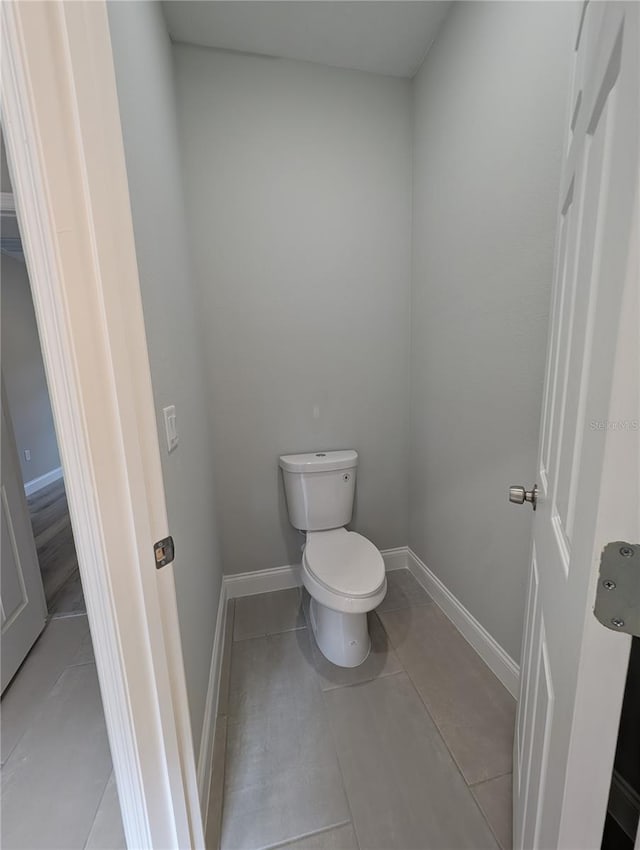 bathroom featuring toilet and tile patterned flooring