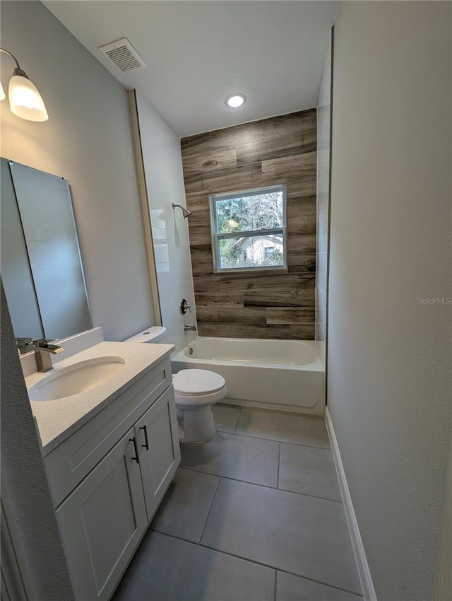 full bathroom with vanity, tile patterned floors, toilet, and tiled shower / bath