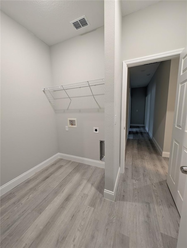 laundry room with washer hookup, light hardwood / wood-style flooring, and hookup for an electric dryer