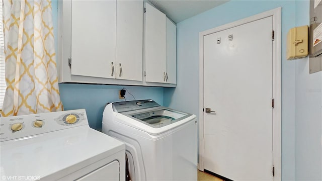 laundry area with cabinets and separate washer and dryer