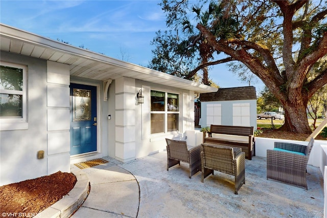 doorway to property with an outdoor living space and a patio