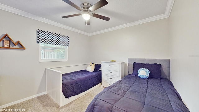 carpeted bedroom featuring ornamental molding and ceiling fan