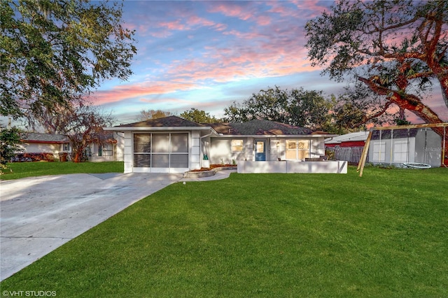 single story home with a storage unit, an outbuilding, fence, a yard, and concrete driveway