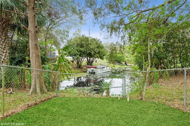 view of yard featuring fence and a water view