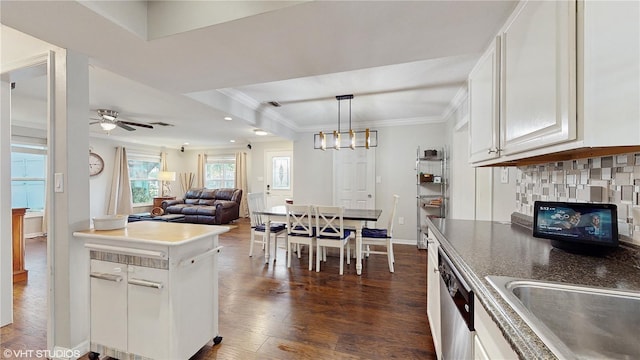 kitchen featuring ornamental molding, backsplash, open floor plan, dark wood finished floors, and white cabinetry