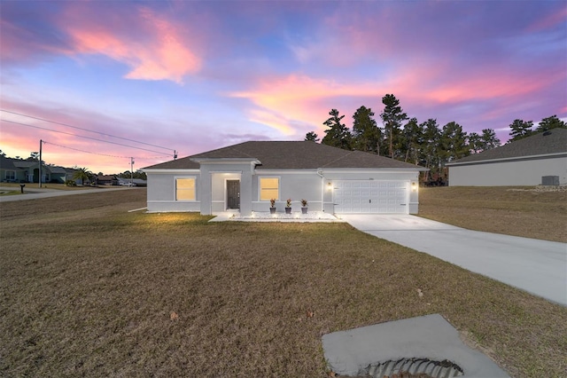 view of front of home featuring a garage and a lawn