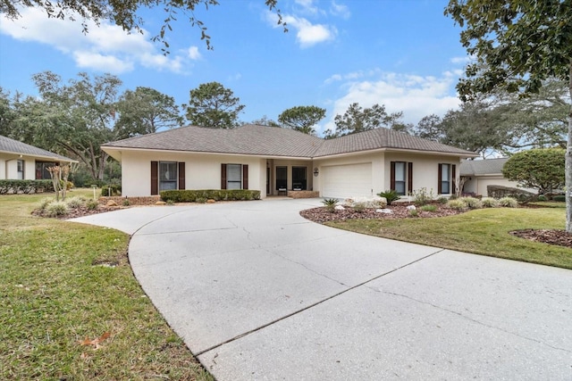 view of front of house with a garage and a front lawn