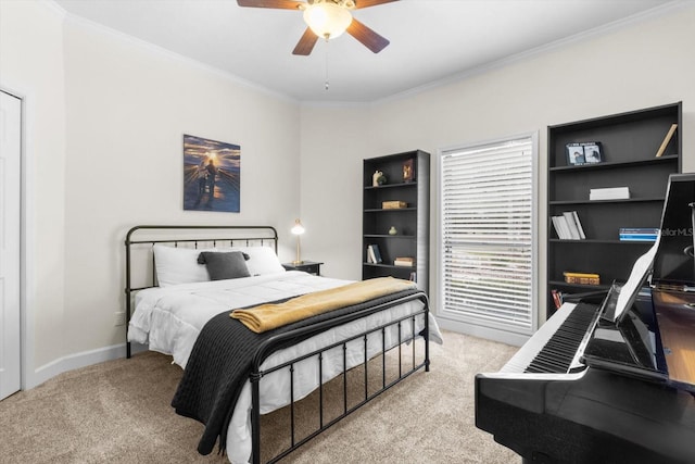 carpeted bedroom featuring crown molding and ceiling fan