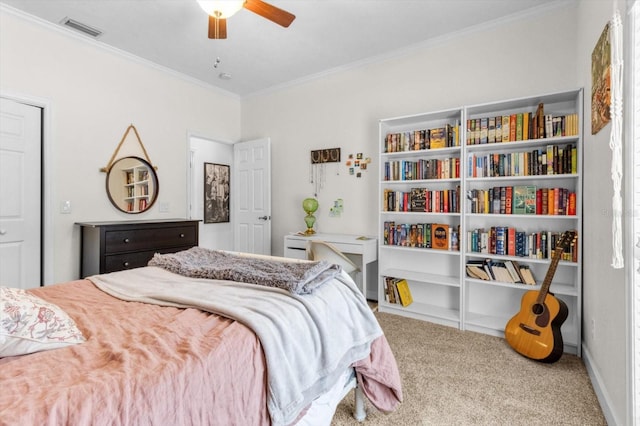 carpeted bedroom with ceiling fan and ornamental molding