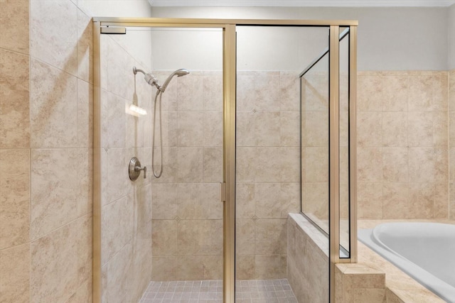 bathroom featuring shower with separate bathtub