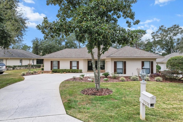 ranch-style home featuring a front yard