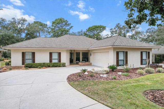 ranch-style home with a garage and a front yard