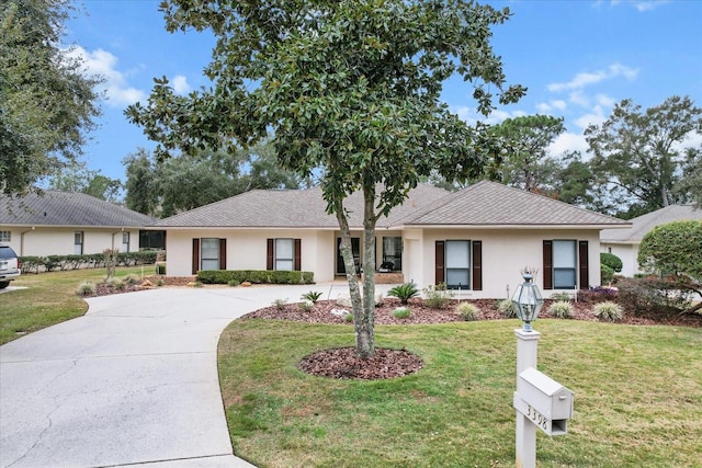 ranch-style home featuring a front yard