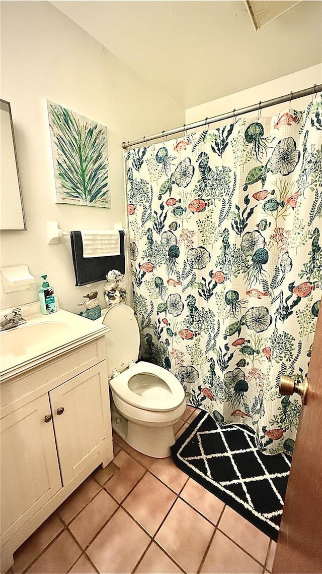 bathroom featuring tile patterned flooring, vanity, a shower with curtain, and toilet