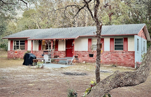 5625 SW 181st Ct, Dunnellon, FL 34432 - ranch-style house featuring covered porch, brick siding, and roof with shingles