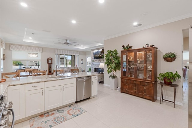 kitchen with dishwasher, sink, white cabinets, and a tray ceiling